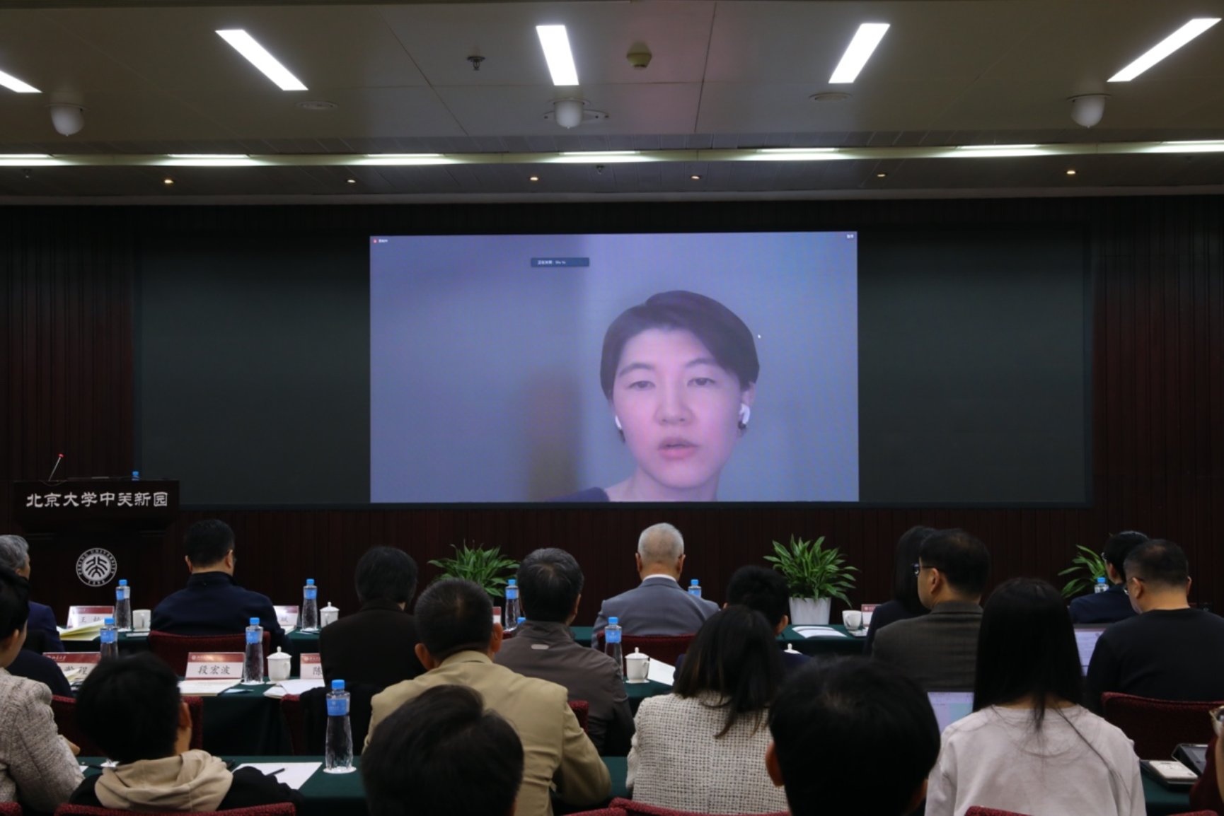 A group of people sitting in a room watching a presentation
Description automatically generated